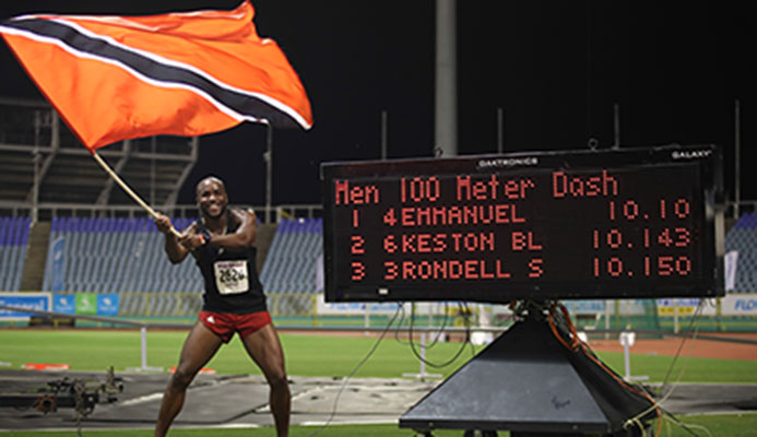 NEW SPRINT KING Emmanuel Callender of Memphis Pioneers waves the national flag in celebration of his triumph in the men's 100 metres sprint finals during the NAAA NGC/Sagicor National Championships at the Hasely Crawford Stadium on Saturday night. Callender clocked 10.10 seconds. Photo: Allan V. Crane/CA-images NEW SPRINT KING Emmanuel Callender of Memphis Pioneers waves the national flag in celebration of his triumph in the men's 100 metres sprint finals during the NAAA NGC/Sagicor National Championships at the Hasely Crawford Stadium on Saturday night. Callender clocked 10.10 seconds. Photo: Allan V. Crane/CA-images