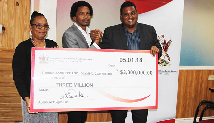 TEAM FUNDS: TTOC general secretary Annette Knott, left, and TTOC president Brian Lewis, centre, are presented with the ceremonial cheque by Minister of Sport and Youth Affairs Darryl Smith at Olympic House, Port of Spain recently. TEAM FUNDS: TTOC general secretary Annette Knott, left, and TTOC president Brian Lewis, centre, are presented with the ceremonial cheque by Minister of Sport and Youth Affairs Darryl Smith at Olympic House, Port of Spain recently.