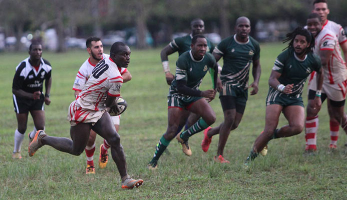 A Caribs player makes a darting run against Harvard yesterday at the Queen's Park Savannah. A Caribs player makes a darting run against Harvard yesterday at the Queen's Park Savannah.