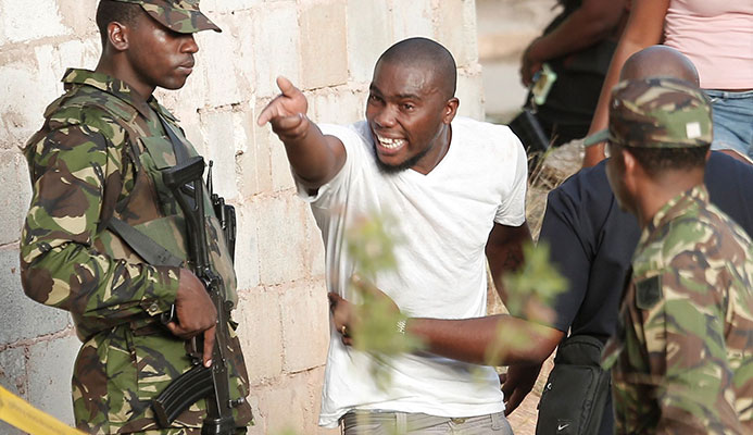 RAGE: Residents often react angrily to the presence of police and soldiers. Here emotions run high at the scene of a double murder in Canada, Laventille. RAGE: Residents often react angrily to the presence of police and soldiers. Here emotions run high at the scene of a double murder in Canada, Laventille.