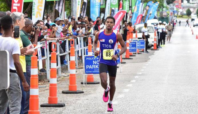 PEREIRA SHINES: Collin Pereira nears the Trinidad and Tobago International Marathon finish line at the Queen’s Park Savannah in Port of Spain, on Sunday. The coast guardsman got home in a personal best two hours, 40 minutes, 49 seconds to secure third spot. Pereira was the first T&T runner to complete the race.   —Photo: JERMAINE CRUICKSHANK PEREIRA SHINES: Collin Pereira nears the Trinidad and Tobago International Marathon finish line at the Queen’s Park Savannah in Port of Spain, on Sunday. The coast guardsman got home in a personal best two hours, 40 minutes, 49 seconds to secure third spot. Pereira was the first T&T runner to complete the race.   —Photo: JERMAINE CRUICKSHANK
