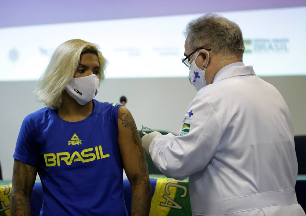 Brazilian swimmer Marcela Cunha (left) gets a shot of the Pfizer vaccine for covid19 from Health Minister Marcelo Queiroga at Urca military base in Rio de Janeiro, Brazil, on Friday. (AP PHOTO) - Brazilian swimmer Marcela Cunha (left) gets a shot of the Pfizer vaccine for covid19 from Health Minister Marcelo Queiroga at Urca military base in Rio de Janeiro, Brazil, on Friday. (AP PHOTO) -