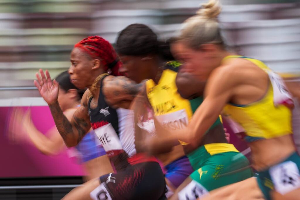 In this July 30 file photo, Michelle-Lee Ahye, left, of Trinidad and Tobago, runs in her heat of the women's 100-meters at the 2020 Summer Olympics, in Tokyo. Ahye was on Wednesday named the TT Olympic Committee's 2021 sportswoman of the year. (AP Photo) - In this July 30 file photo, Michelle-Lee Ahye, left, of Trinidad and Tobago, runs in her heat of the women's 100-meters at the 2020 Summer Olympics, in Tokyo. Ahye was on Wednesday named the TT Olympic Committee's 2021 sportswoman of the year. (AP Photo) -
