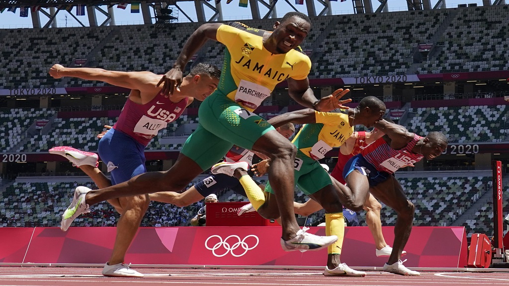 Hansle Parchment (left), of Jamaica, wins the men's 110m hurdles final ahead of Grant Holloway (right), of the United States, at the 2020 Summer Olympics, Thursday, Aug. 5, 2021, in Tokyo, Japan. Parchment's compatriot Ronald Levy (2nd right) finished third. (AP Photo/David J. Phillip) Hansle Parchment (left), of Jamaica, wins the men's 110m hurdles final ahead of Grant Holloway (right), of the United States, at the 2020 Summer Olympics, Thursday, Aug. 5, 2021, in Tokyo, Japan. Parchment's compatriot Ronald Levy (2nd right) finished third. (AP Photo/David J. Phillip)