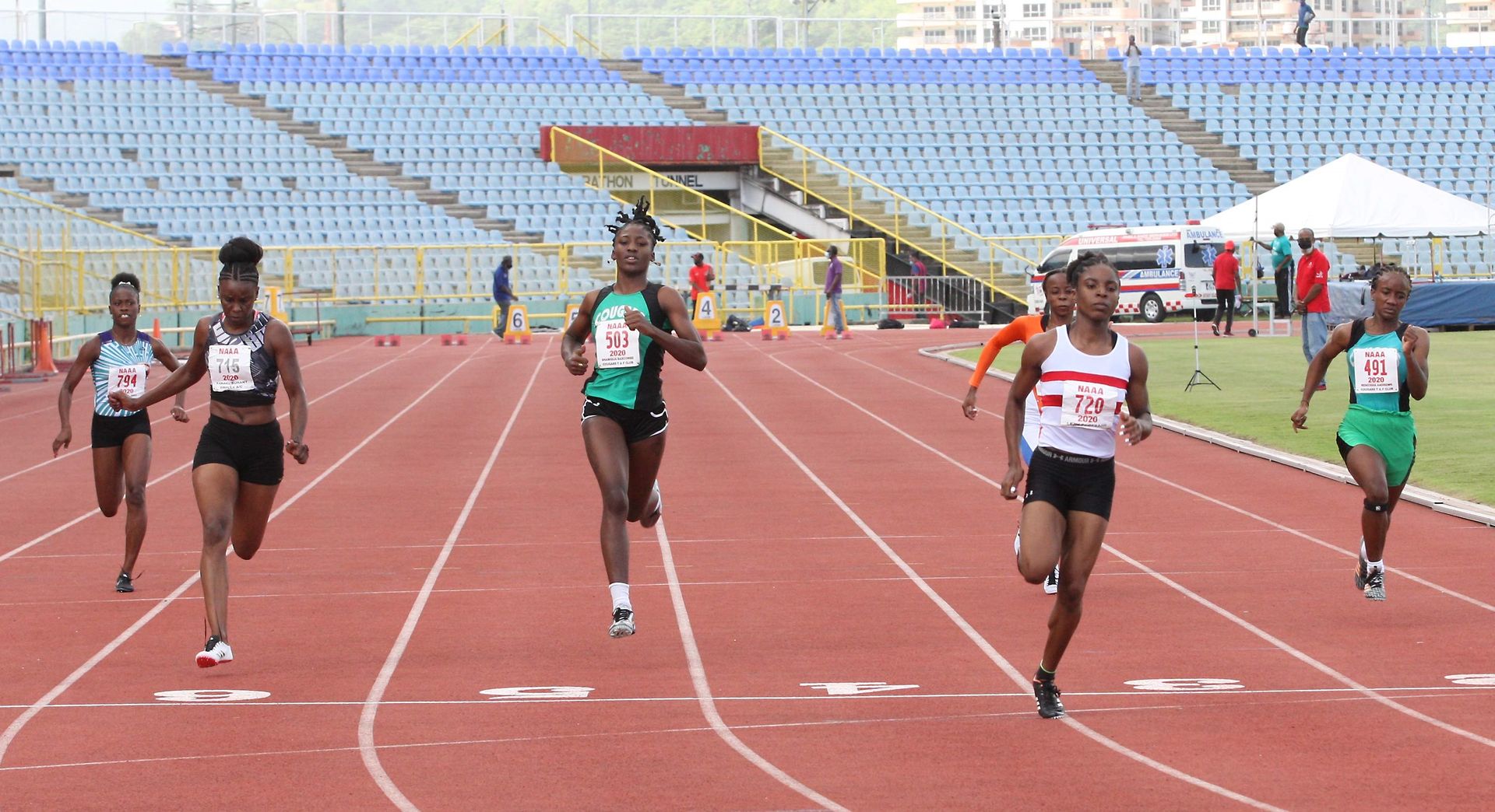 Leah Bertrand of Simplex, fourth from left, eases over the line to win the women's 100 metres with a time of 11.52 seconds ahead of second-place Kamaria Durant also of Simplex (11.90), second from left, and third-placed Shaniqua Bascombe (Cougars), third from left, in 11.97 at the Olympic Trials hosted by the NAAATT at the Hasely Crawford Stadium in Port-of-Spain yesterday.  Anthony Harris Leah Bertrand of Simplex, fourth from left, eases over the line to win the women's 100 metres with a time of 11.52 seconds ahead of second-place Kamaria Durant also of Simplex (11.90), second from left, and third-placed Shaniqua Bascombe (Cougars), third from left, in 11.97 at the Olympic Trials hosted by the NAAATT at the Hasely Crawford Stadium in Port-of-Spain yesterday.  Anthony Harris