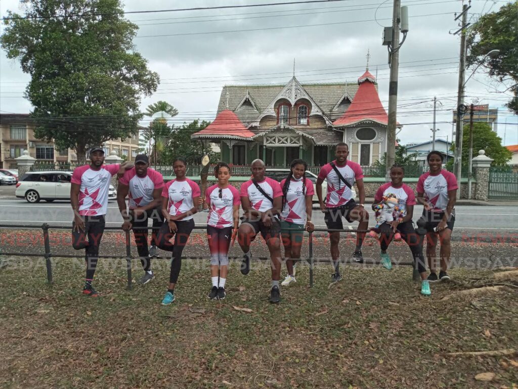 TT women’s boxer Tianna Guy, fourth from left, holds the Queen’s Baton at the Queen’s Park Savannah in Port of Spain, on Wednesday. She is joined by national athletes and former athletes. - Jelani Beckles TT women’s boxer Tianna Guy, fourth from left, holds the Queen’s Baton at the Queen’s Park Savannah in Port of Spain, on Wednesday. She is joined by national athletes and former athletes. - Jelani Beckles