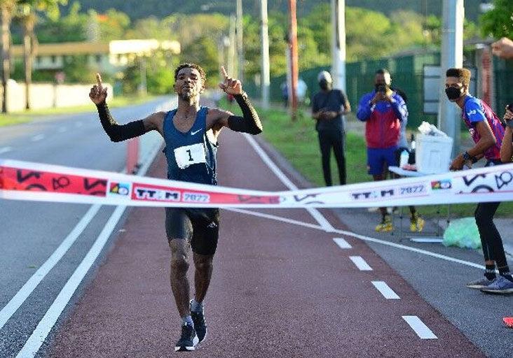 TRIUMPHANT: Guyana’s Kelvin Johnson raises his arms in victory after taking the 2022 elite category of the Trinidad and Tobago International Marathon (TTIM) last year in Chaguaramas. Johnson will defend his crown on a new route tomorrow for the 41st edition of the TTIM.  —Photo: ISHMAEL SALANDY (Image obtained via trinidadexpress.com) TRIUMPHANT: Guyana’s Kelvin Johnson raises his arms in victory after taking the 2022 elite category of the Trinidad and Tobago International Marathon (TTIM) last year in Chaguaramas. Johnson will defend his crown on a new route tomorrow for the 41st edition of the TTIM.  —Photo: ISHMAEL SALANDY (Image obtained via trinidadexpress.com)