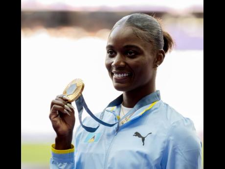 Gladstone Taylor Olympic 100 metres champion Julien Alfred of St Lucia displays her gold medal during the medal ceremony for the event at the Stade de France in Paris, France, yesterday. (Image obtained at jamaica-gleaner.com) Gladstone Taylor Olympic 100 metres champion Julien Alfred of St Lucia displays her gold medal during the medal ceremony for the event at the Stade de France in Paris, France, yesterday. (Image obtained at jamaica-gleaner.com)