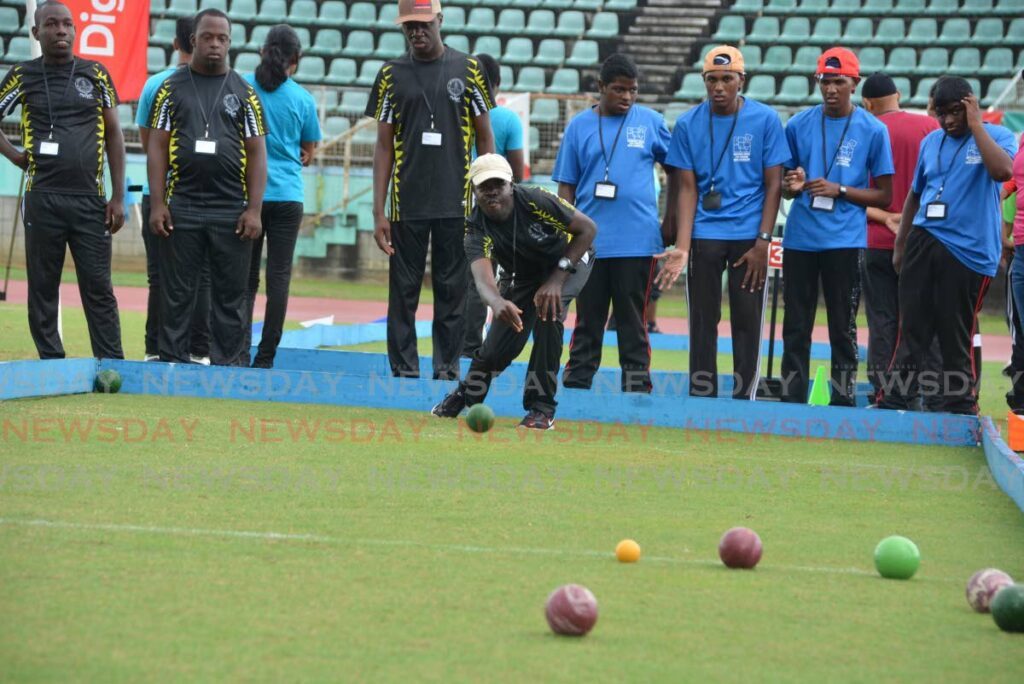 A member of Memisa Centre rolls the ball during a game of bocce vs competitors of National Centre for Persons with Disability at the opening of the 43rd annual Special Olympics National Games at Manny Ramjohn Stadium in Marabella on May 10. - Photo by Innis Francis (Image obtained at newsday.co.tt)