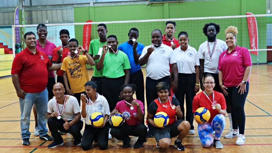 Digicel Foundation, board director, Roger Pedro (left); head volleyball coach Avlon Tate (back row); Candace Young, assistant volleyball coach (right); with volleyball athletes showing off their medals at Saturday’s Special Olympics TT National Games volleyball competition in San Fernando. - Photo courtesy SwayoDigital. (Image obtained at newsday.co.tt)