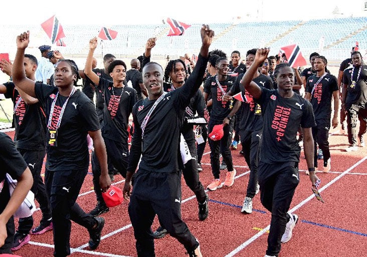 CROWD PLEASERS: Team TTO athletes acknowledge the cheers of their adoring home fans at the Carifta opening ceremony at the Hasely Crawford Stadium in Port of Spain, yesterday. Both the Carifta Games and the Carifta Aquatic Championships start today.  —Photo: JERMAINE CRUIKSHANK (Image obtained at trinidadexpress.com)
