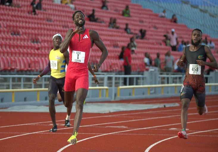 ALL SMILES: Jereem “The Dream” Richards, centre, is all smiles at the end of the men’s 200 metres final, on day two of the NAAATT/NGC National Senior Track and Field Championships at the Hasely Crawford Stadium, in Port of Spain, yesterday. Richards won in 20.21 seconds, ahead of Elijah Joseph, right, and Daeshaun Cole, left. —Photo: DENNIS ALLEN for @TTGameplan (Image obtained at trinidadexpress.com)