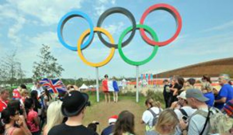 Fans pose for pictures at the Olympic Park, London, on the final day of the London 2012 Olympics